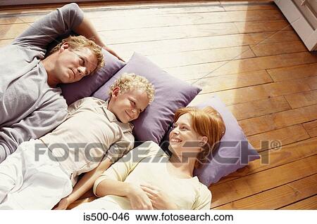 Stock Photograph - Family lying on floor. Fotosearch