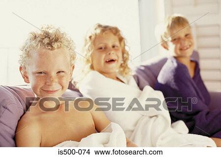 Picture - Girl and boys on sofa. Fotosearch