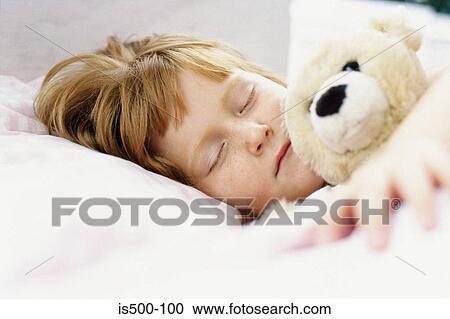Stock Image - Girl asleep in bed. Fotosearch