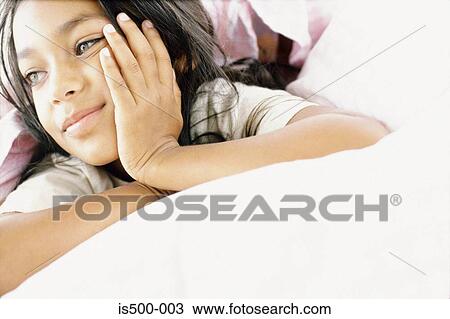 Girl lying on bed View Large Photo Image Stock Image - Girl lying on bed. Fotosearch