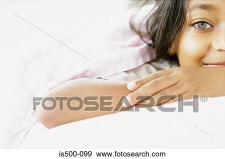 Stock Photo - Girl lying on bed. Fotosearch