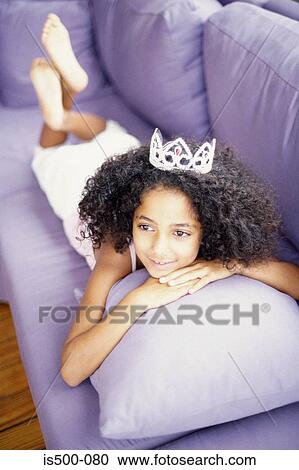 Stock Image - Girl lying on sofa. Fotosearch