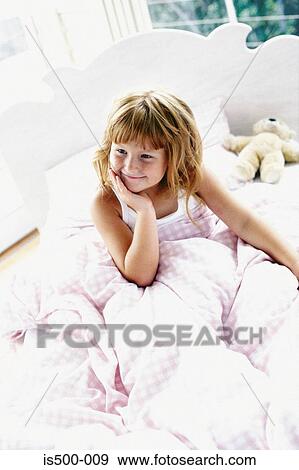Stock Photo - Girl sitting in bed. Fotosearch
