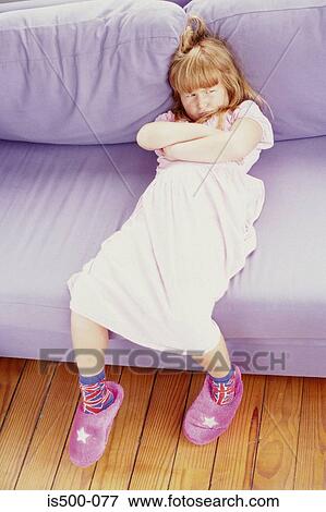 Girl sulking on sofa View Large Photo Image Stock Photo - Girl sulking on sofa. Fotosearch