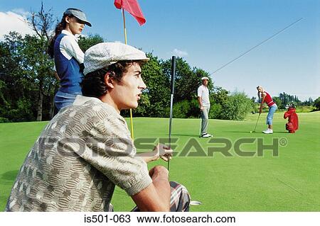Stock Image - Friends at the golf course. Fotosearch