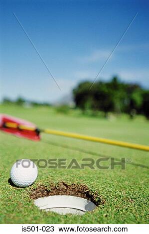 Golf ball next to hole View Large Photo Image Stock Image - Golf ball next to hole. Fotosearch