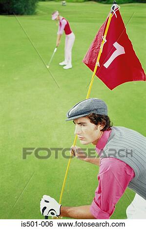 Stock Photograph - Man and woman playing golf. Fotosearch