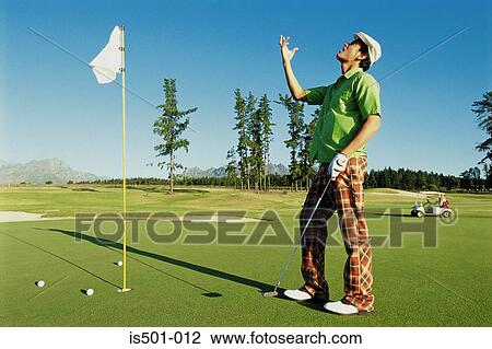 Stock Image - Man playing golf. Fotosearch
