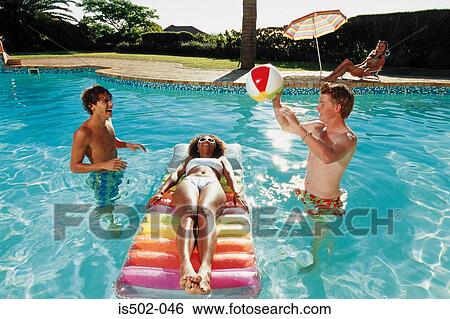 Playing with a ball in the pool View Large Photo Image Stock Photograph - Playing with a ball in the pool. Fotosearch