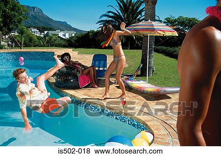 Young man falling into pool View Large Photo Image Stock Photo - Young man falling into pool. Fotosearch