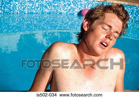 Young man sunbathing View Large Photo Image Picture - Young man sunbathing. Fotosearch