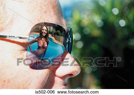 Young woman reflected in sunglasses View Large Photo Image Stock Photograph - Young woman reflected in sunglasses. Fotosearch