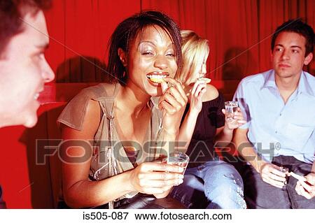 Stock Photo - Friends chatting in nightclub. Fotosearch