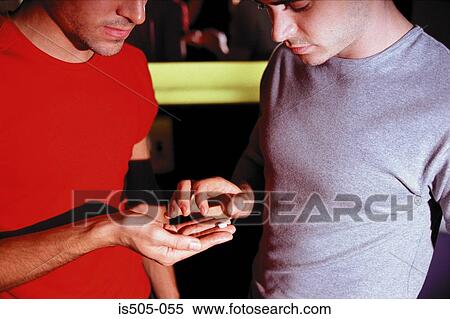 Stock Photography - Male hand holding recreational drugs. Fotosearch