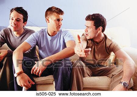 Men joking around on sofa View Large Photo Image Stock Photography - Men joking around on sofa. Fotosearch