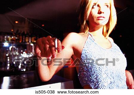 Woman smoking in nightclub View Large Photo Image Stock Photo - Woman smoking in nightclub. Fotosearch