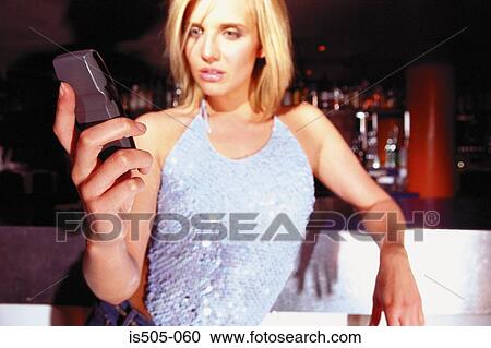 Woman with cellphone in nightclub View Large Photo Image Stock Image - Woman with cellphone in nightclub. Fotosearch