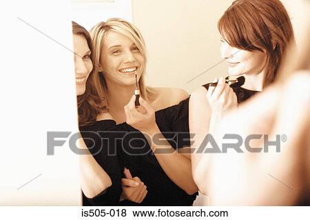 Stock Photo - Women applying makeup. Fotosearch