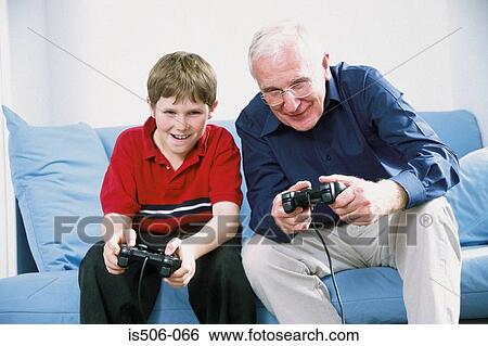 Stock Image - Grandfather and grandson playing with computer game. Fotosearch - Search Stock Photography, Poster Photos, Pictures, and Photo Clip Art
