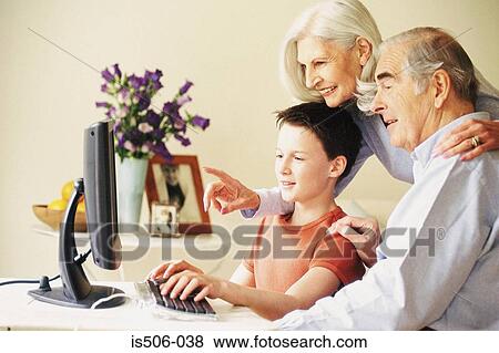 Grandparents and grandson using computer View Large Photo Image Stock Photo - Grandparents and grandson using computer. Fotosearch