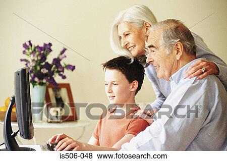 Grandparents and grandson using computer View Large Photo Image Stock Photo - Grandparents and grandson using computer. Fotosearch
