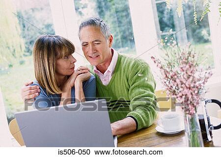 Man and woman using laptop computer View Large Photo Image Stock Image - Man and woman using laptop computer. Fotosearch