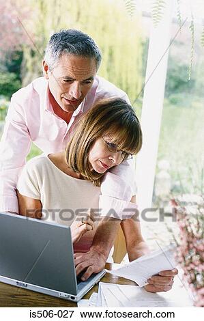 Man and woman using laptop computer View Large Photo Image Stock Photo - Man and woman using laptop computer. Fotosearch