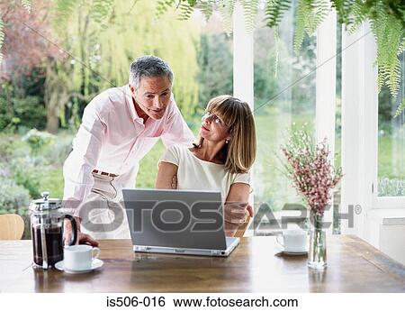 Man and woman using laptop computer View Large Photo Image Stock Photograph - Man and woman using laptop computer. Fotosearch