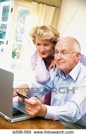 Stock Photography - Man and woman using laptop computer. Fotosearch