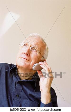 Man talking on cellphone View Large Photo Image Stock Image - Man talking on cellphone. Fotosearch