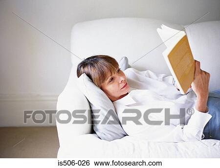 Woman reading on sofa View Large Photo Image Stock Photograph - Woman reading on sofa. Fotosearch