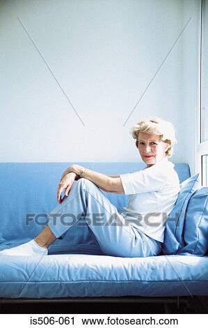 Woman relaxing on sofa View Large Photo Image Stock Image - Woman relaxing on sofa. Fotosearch
