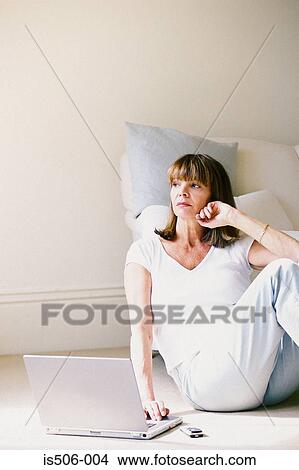 Picture - Woman using laptop computer. Fotosearch