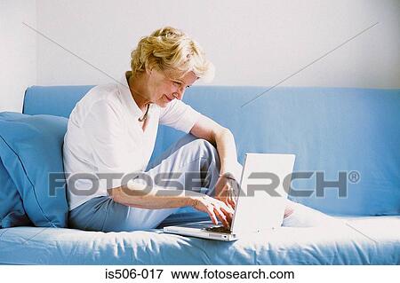 Stock Photo - Woman using laptop computer. Fotosearch