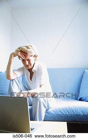 Stock Photograph - Woman using laptop computer. Fotosearch