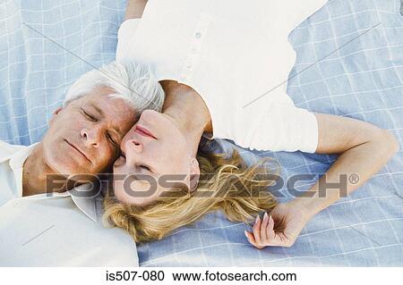 Couple lying down together View Large Photo Image Stock Image - Couple lying down together. Fotosearch