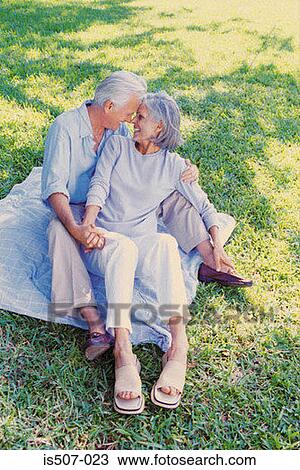 Stock Image - Intimate couple in park. Fotosearch