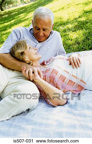 Stock Image - Intimate couple in park. Fotosearch