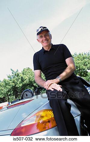 Stock Image - Man with his porche convertable. Fotosearch