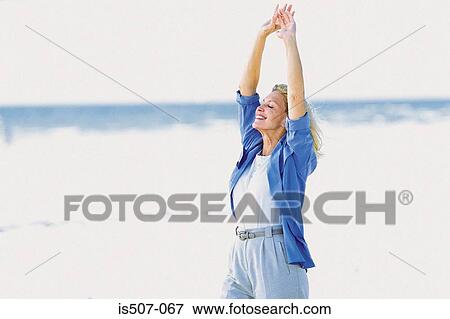 Woman stretching by the sea View Large Photo Image Stock Photo - Woman stretching by the sea. Fotosearch