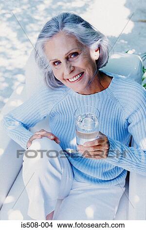 Ageing woman drinking outdoors View Large Photo Image Picture - Ageing woman drinking outdoors. Fotosearch