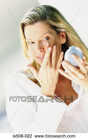 Woman applying makeup View Large Photo Image Stock Image - Woman applying makeup. Fotosearch