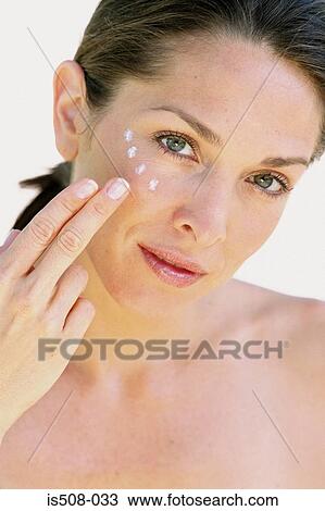Woman applying makeup View Large Photo Image Stock Image - Woman applying makeup. Fotosearch