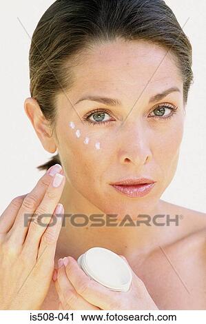 Woman applying makeup View Large Photo Image Stock Image - Woman applying makeup. Fotosearch