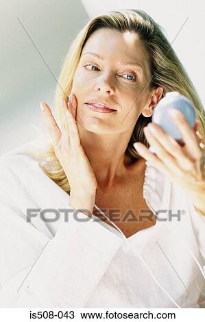 Stock Image - Woman applying makeup. Fotosearch