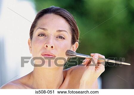 Woman applying makeup View Large Photo Image Stock Image - Woman applying makeup. Fotosearch