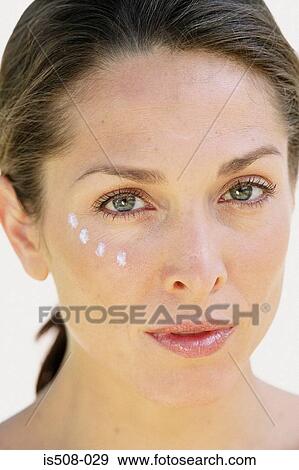 Stock Photo - Woman applying makeup. Fotosearch