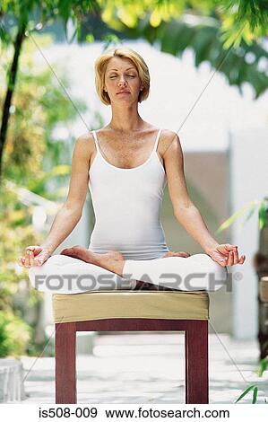 Stock Photo - Woman doing yoga outdoors. Fotosearch