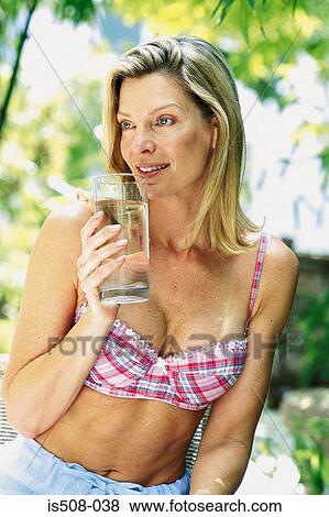 Woman drinking outdoors View Large Photo Image Stock Photo - Woman drinking outdoors. Fotosearch