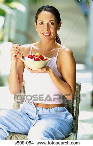 Woman eating outdoors View Large Photo Image Picture - Woman eating outdoors. Fotosearch
